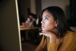 Woman focusing on computer screen